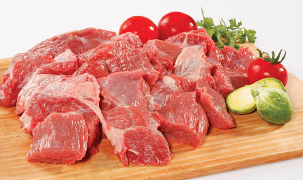 istock fresh raw red cubed meat chunk on wooden cut board isolated over white background 901343070