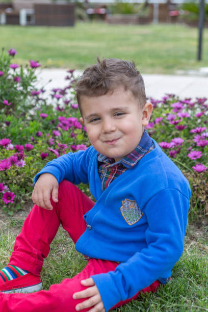 istock Happy boy sitting in front or back yard 901349506
