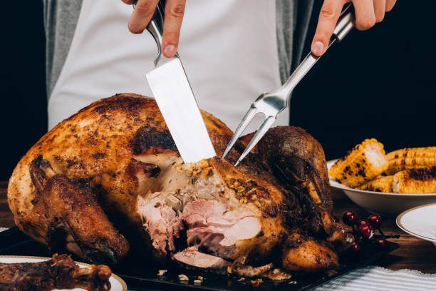 istock Man cutting baked turkey 901350036