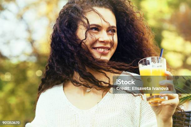 Young Woman Drinking Orange Juice Stock Photo - Download Image Now - Fruit Juice, 20-29 Years, Adult