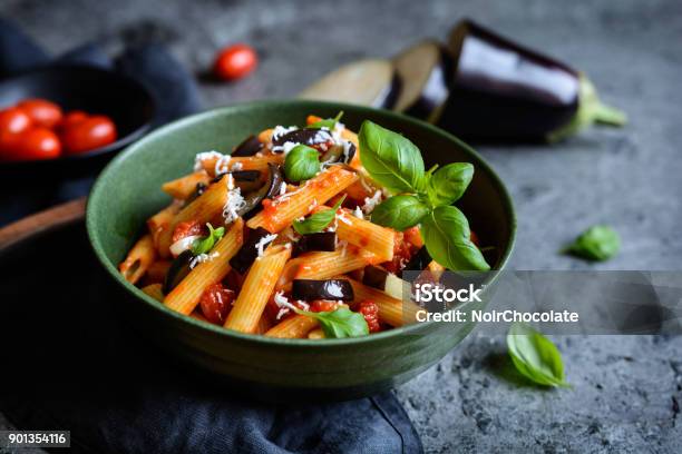 Traditional Italian Pasta Alla Norma With Eggplant Tomato Cheese And Basil Stock Photo - Download Image Now