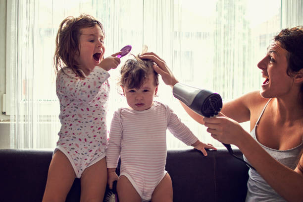 Mother drying hair of her daughters Mother drying hair of her daughters short human hair women little girls stock pictures, royalty-free photos & images