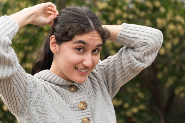istock Young Latin Woman fixing hair 901362832