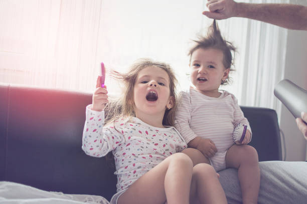 Father drying hair of her daughters Father drying hair of her daughters short human hair women little girls stock pictures, royalty-free photos & images