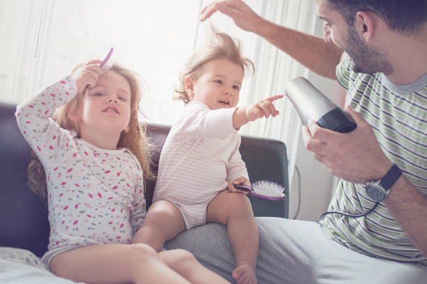 Father drying hair of her daughters Father drying hair of her daughters short human hair women little girls stock pictures, royalty-free photos & images