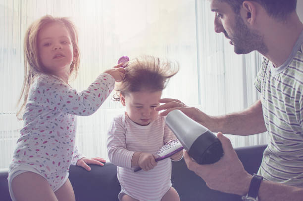 Father drying hair of her daughters Father drying hair of her daughters short human hair women little girls stock pictures, royalty-free photos & images