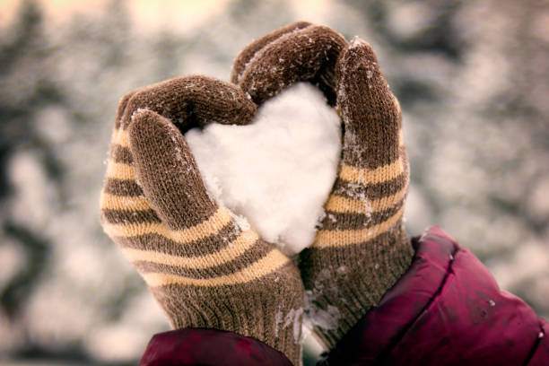 istock Hands holding snow heart. Love. 901373646