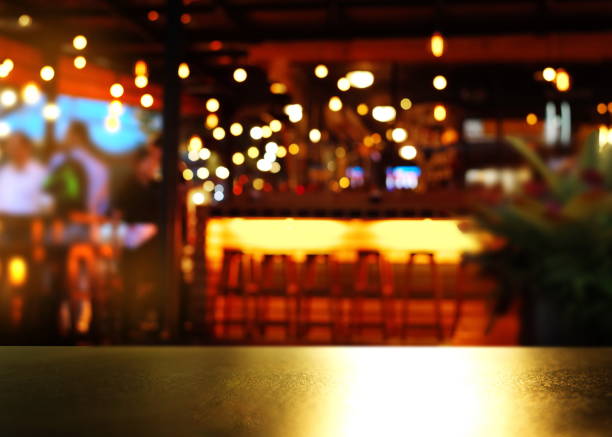 top of reflection bokeh light on table with blur bar light night party background