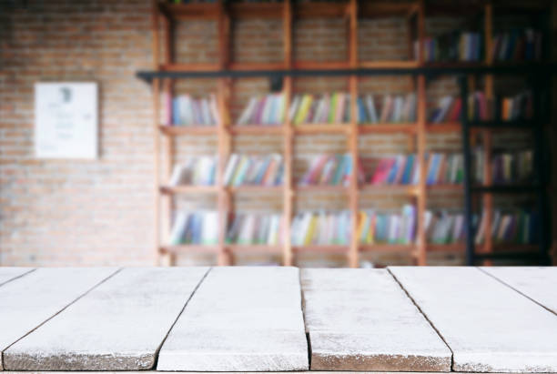 istock Selected focus empty old wooden table and Library or Bookstore blur background with bokeh image. for your photomontage or product display 901374274