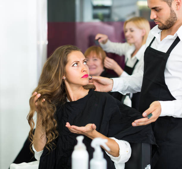 Displeased client and hairdresser Displeased young girl negatively talking with the hairdresser angry hairstylist stock pictures, royalty-free photos & images