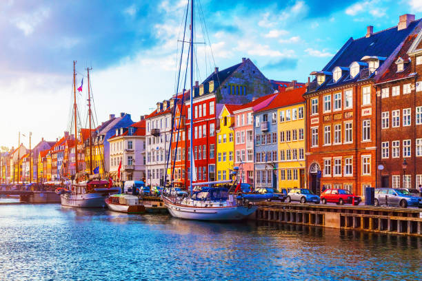 Nyhavn, Copenhagen, Denmark Scenic summer sunset view of Nyhavn pier with color buildings, ships, yachts and other boats in the Old Town of Copenhagen, Denmark copenhagen photos stock pictures, royalty-free photos & images