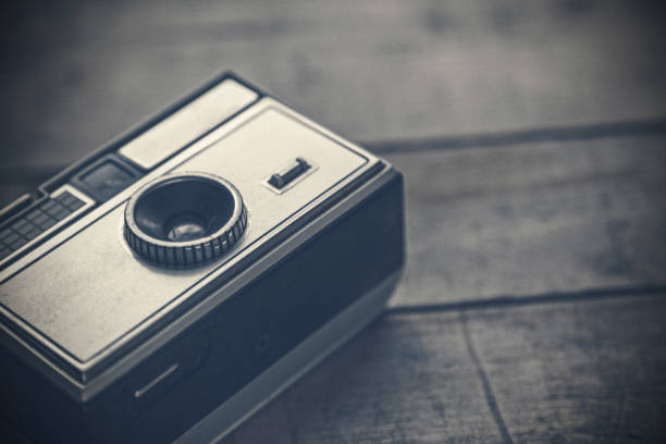 Close-up of a vintage film camera on a wooden surface. Film 