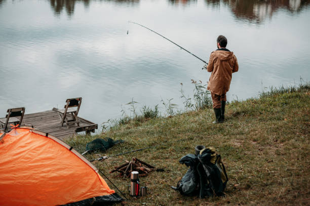 istock fisherman fishing with rod 901375922