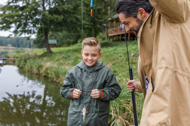 istock father and son with little fish 901381370