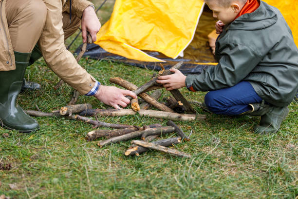 istock father and son making bonfire with sticks 901383004