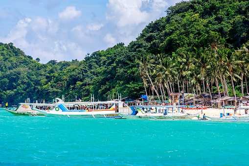 BORACAY ISLAND, PHILIPPINES - November 18, 2017 : Puka beach with Hopping tour boats view from water in Boracay