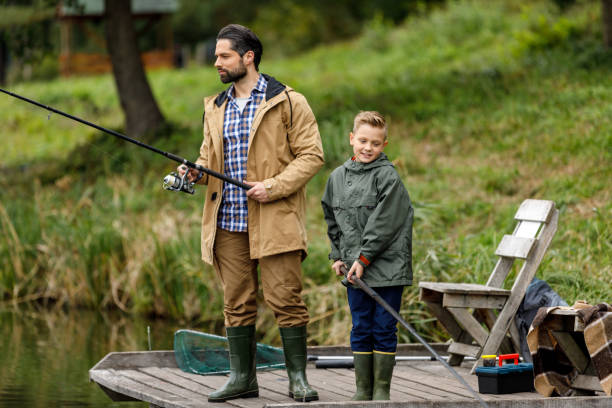 istock father and son fishing on pier 901385884