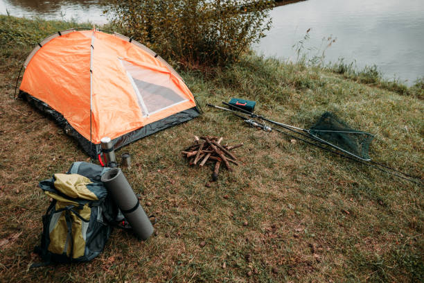 istock tent on countryside with lake 901386374