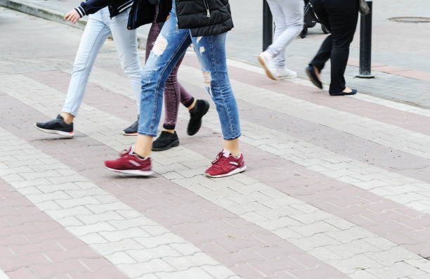 istock Women's legs on a pedestrian crossing. 901397848