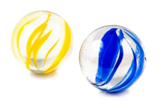A Pair of Glass Cateye Marbles Isolated on a White Background.