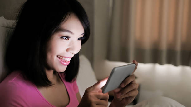 istock woman play mobile game 901405104