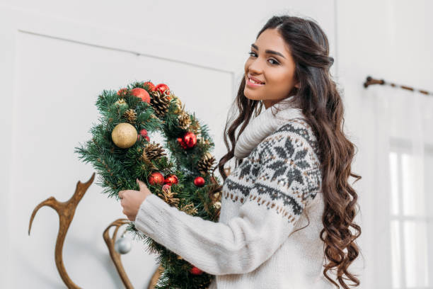 istock woman holding christmas wreath 901413318