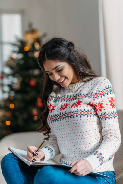 istock woman writing in notebook on christmas 901422068