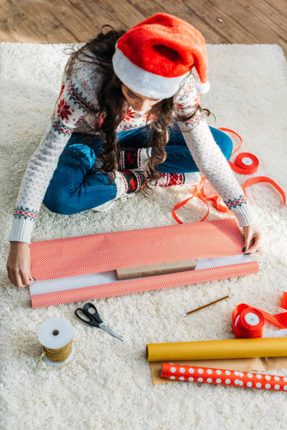 istock woman packing christmas gift 901424252