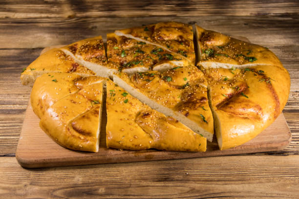 istock Sliced pita bread on cutting board on wooden table 901425192