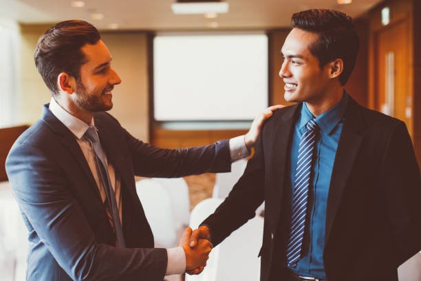 istock Smiling Business Leader Congratulating Colleague 901427712