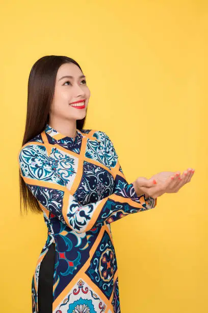 Vietnamese woman traditional festival costume Ao Dai gesture hands.