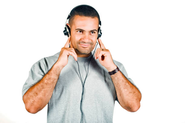 Young African mixed race man listening music in the earphones