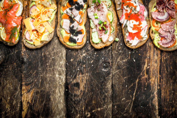 istock Sandwiches with salmon, cheese, mushrooms and fresh vegetables. 901436746