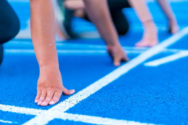 sprint start in track and field on a blue track