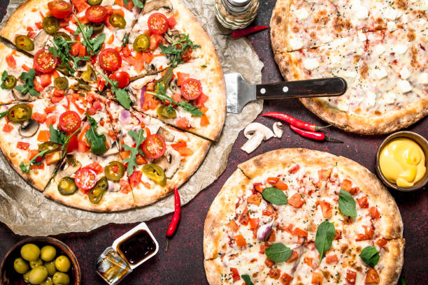 istock variety of pizzas with sauces. 901440062
