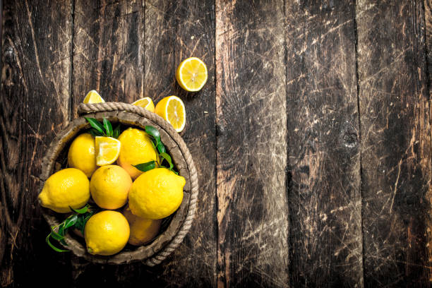 istock Fresh lemons in a wooden bucket. 901440148