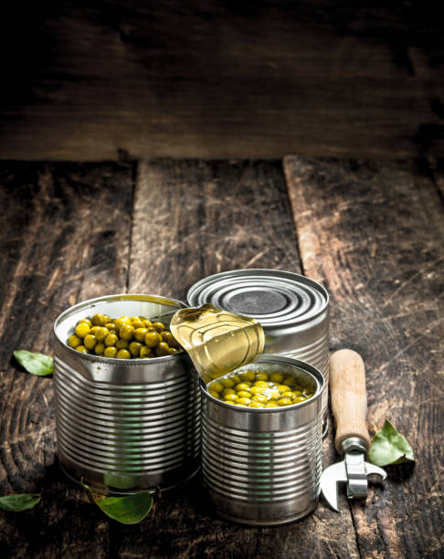 istock Canned green peas in a tin can with opener. 901441640