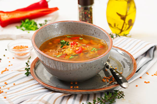 istock Appetizing soup with red lentils, meat, red paprika and fragrant thyme 901444726