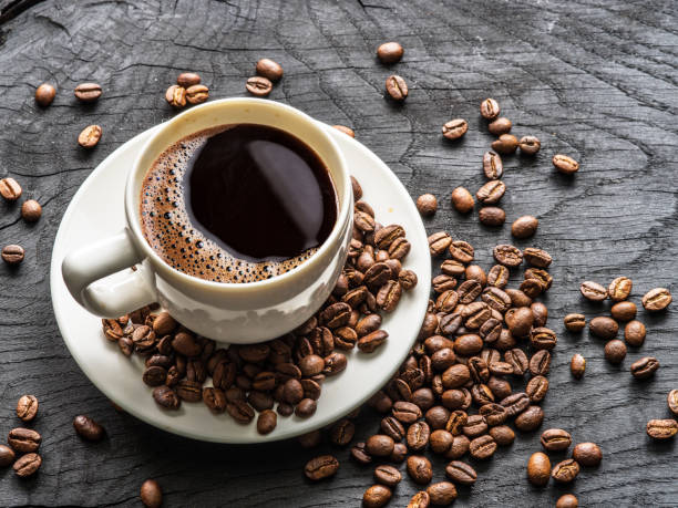 istock Cup of coffee surrounded by coffee beans. Top view. 901451886