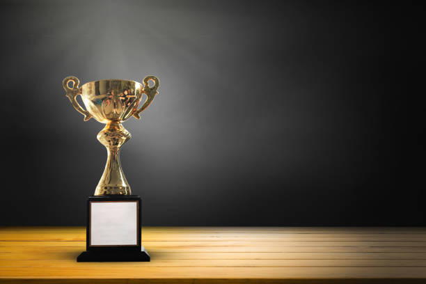 istock Champion golden trophy on wooden table background. copy space for text. 901452040