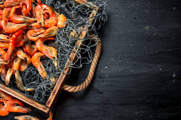 istock Fresh shrimp in a fishing net on a tray. 901452804