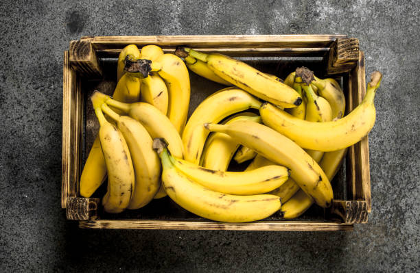istock Fresh bananas in an old box. 901453256