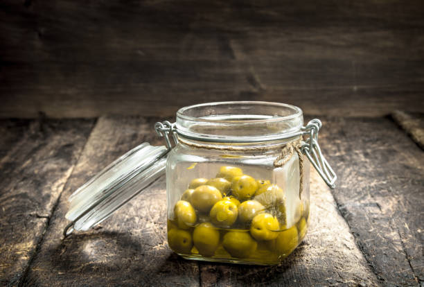 istock Pickled olives in glass jar. 901456918