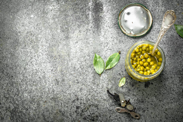 istock Marinated green peas in glass jar. 901457368