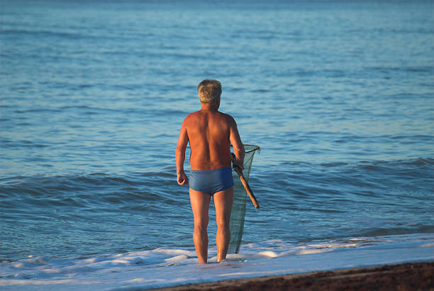 Fisherman with net in the sea