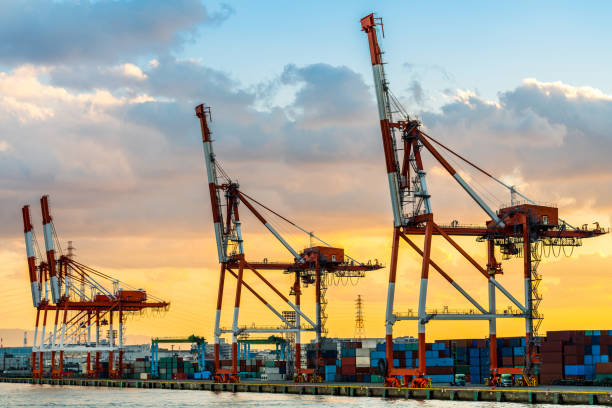 istock Sunset at the container port cargo, export container to international. 901462034