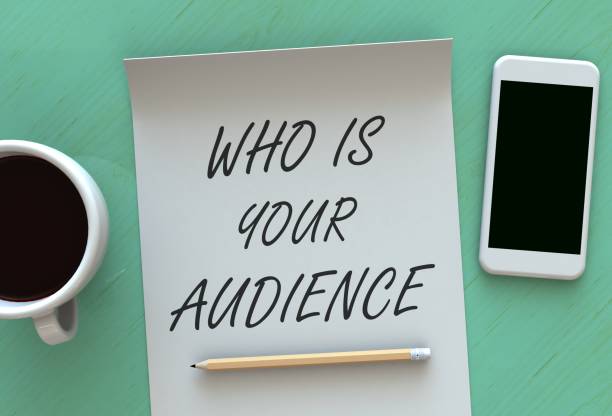 istock WHO IS YOUR AUDIENCE, message on paper, smart phone and coffee on table 901465452