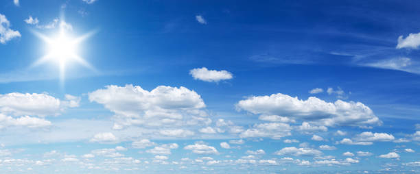 istock White heap clouds and bright sun in the blue sky. 901468548