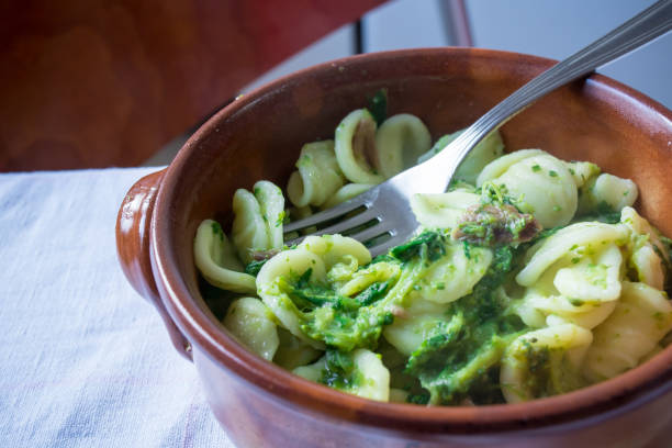 Horizontal View Of Close Up Of A Hot And Smoking Italian Traditional Food Called Orecchiette Con Le Rape Horizontal View Of Close Up Of A Hot And Smoking Italian Traditional Food Called Orecchiette Con Le Rape On Blur Background brassica rapa stock pictures, royalty-free photos & images