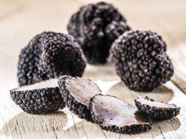 istock Black truffles on the old wooden table. 901468954
